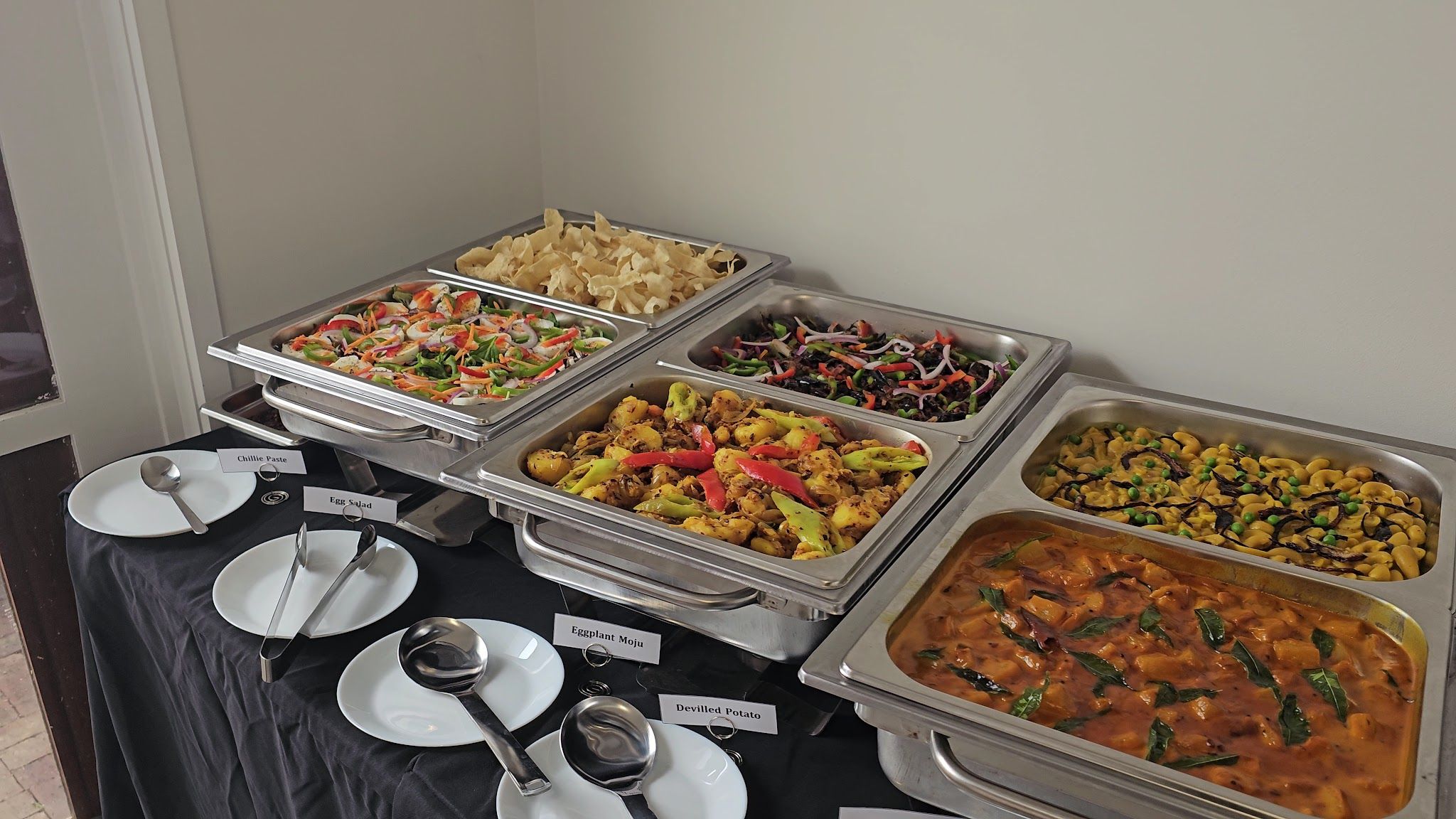 Sri Lankan catering buffet display table with colourful dishes and serving equipment