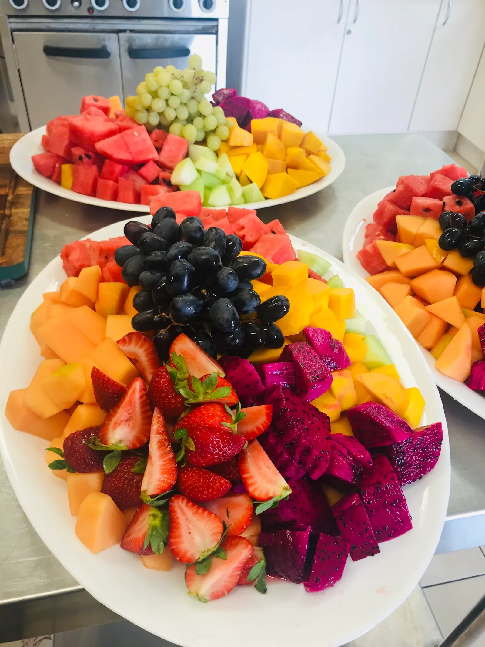 Vibrant fresh fruit platter with dragon fruit, melon and strawberries